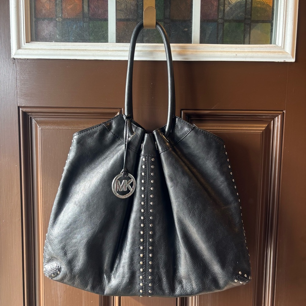 Michael Kors Astor studded black leather tote bag.